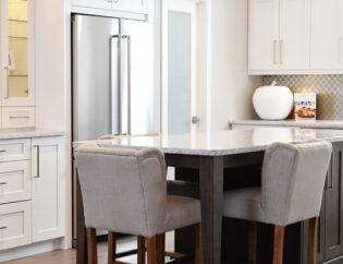 A kitchen after a deep clean service near Kingston London dinning table with three chairs near a fridge